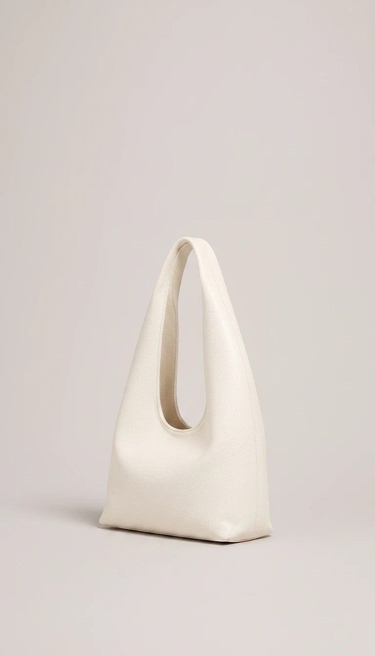 ALESSIA JADE Aster shoulder bag in cream with a sculptural silhouette and seamless integrated handle.